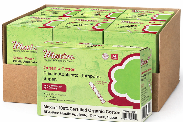 Case pack of Maxim organic cotton plastic applicator tampons (super, 14 count) in green boxes, featuring BPA-free applicator and claims of no chlorine bleaching, non-irritating, and no added fragrances or synthetics